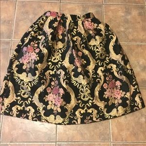 Black skirt with gold and pink designs.